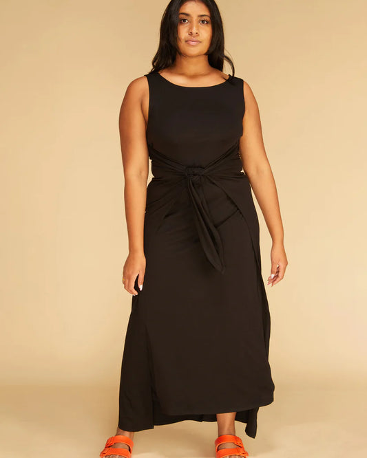 Model showcasing Leni Wrap Dress with boat neck knit maxi dress with wrap tie style front.
