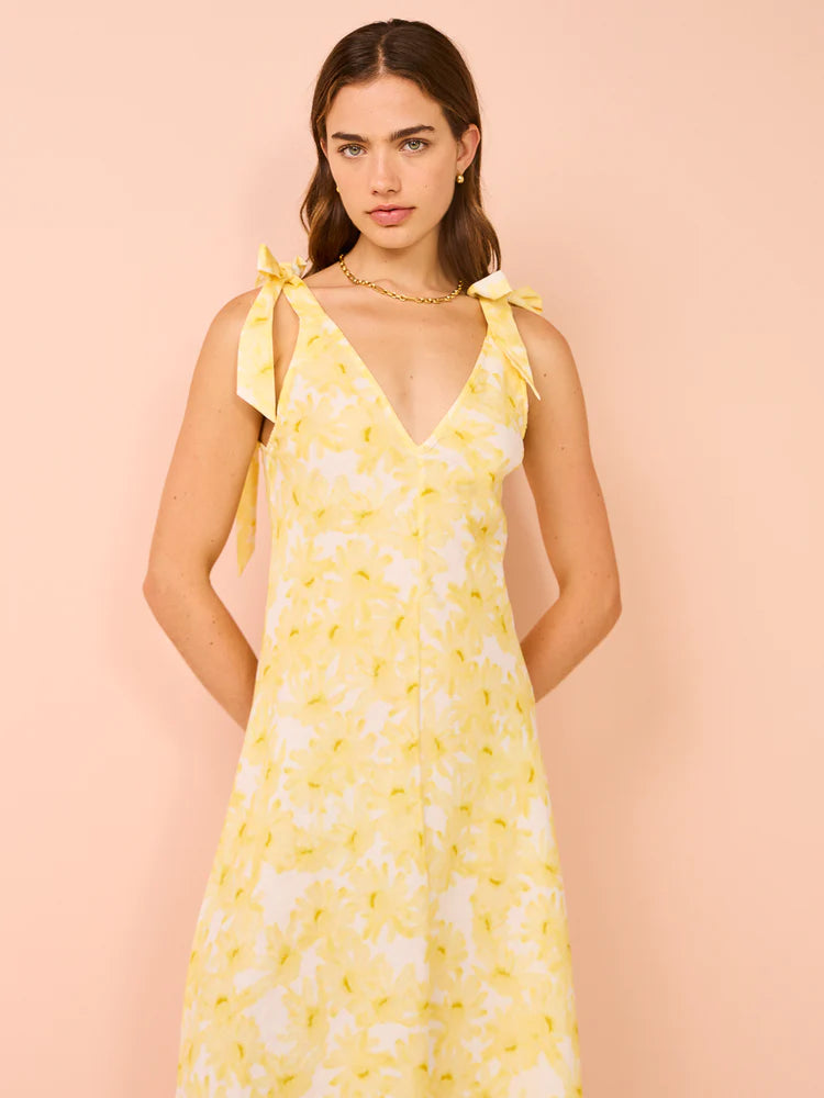 Model wearing Kinney Emery Dress in yellow, showcasing adjustable straps and relaxed A-line silhouette - Designer Dress Rentals from Lend the Label