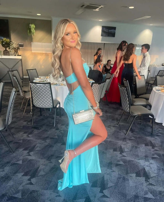 Split in leg and low back. Glamourous dress for model to wear to school ball or formal event.