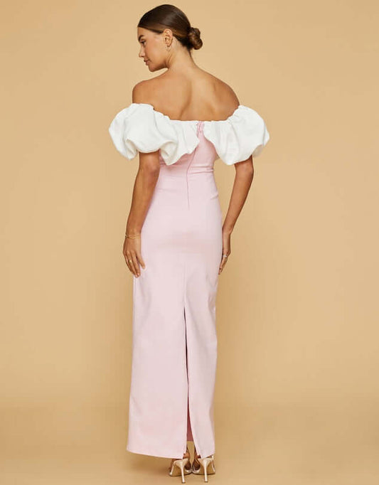 Model wearing Venus gown, showing off back of the dress. With ruffled details and slim fit.