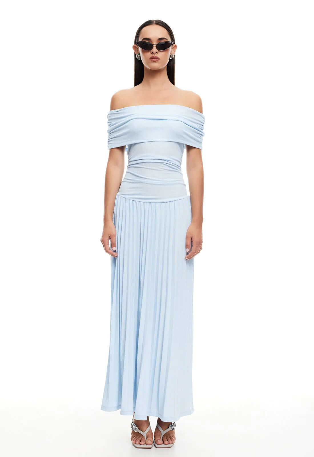 Model wearing a light blue off-the-shoulder maxi dress from Lioness, showcasing effortless glamour and contemporary style.