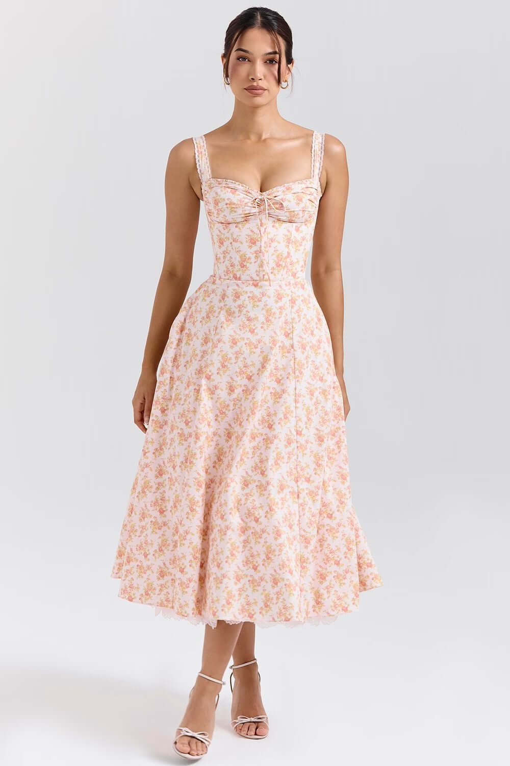 Rosalee Peach Poppy Print Bustier Sundress worn by a model, featuring a gathered bust and feminine silhouette.