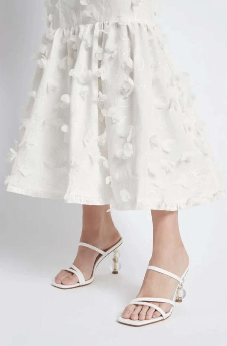 Dress is fully lined, Petal Dreams, raw edge tassel on dress hem showcasing effortless glamour and contemporary style.