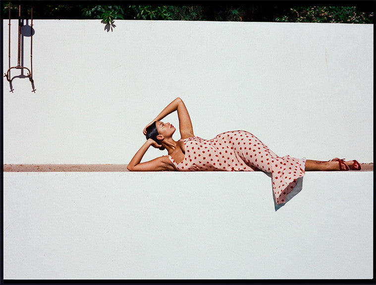 Model wearing Lend the Label designer dress rental. Lying down in the sunshine outside.