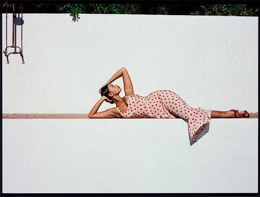 Model wearing Lend the Label designer dress rental. Lying down in the sunshine outside.