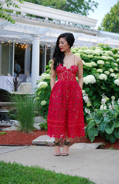 Model wearing Self Portrait - Azaelea Dress in Red in a garden setting. Rent this designer dress with Lend the Label
