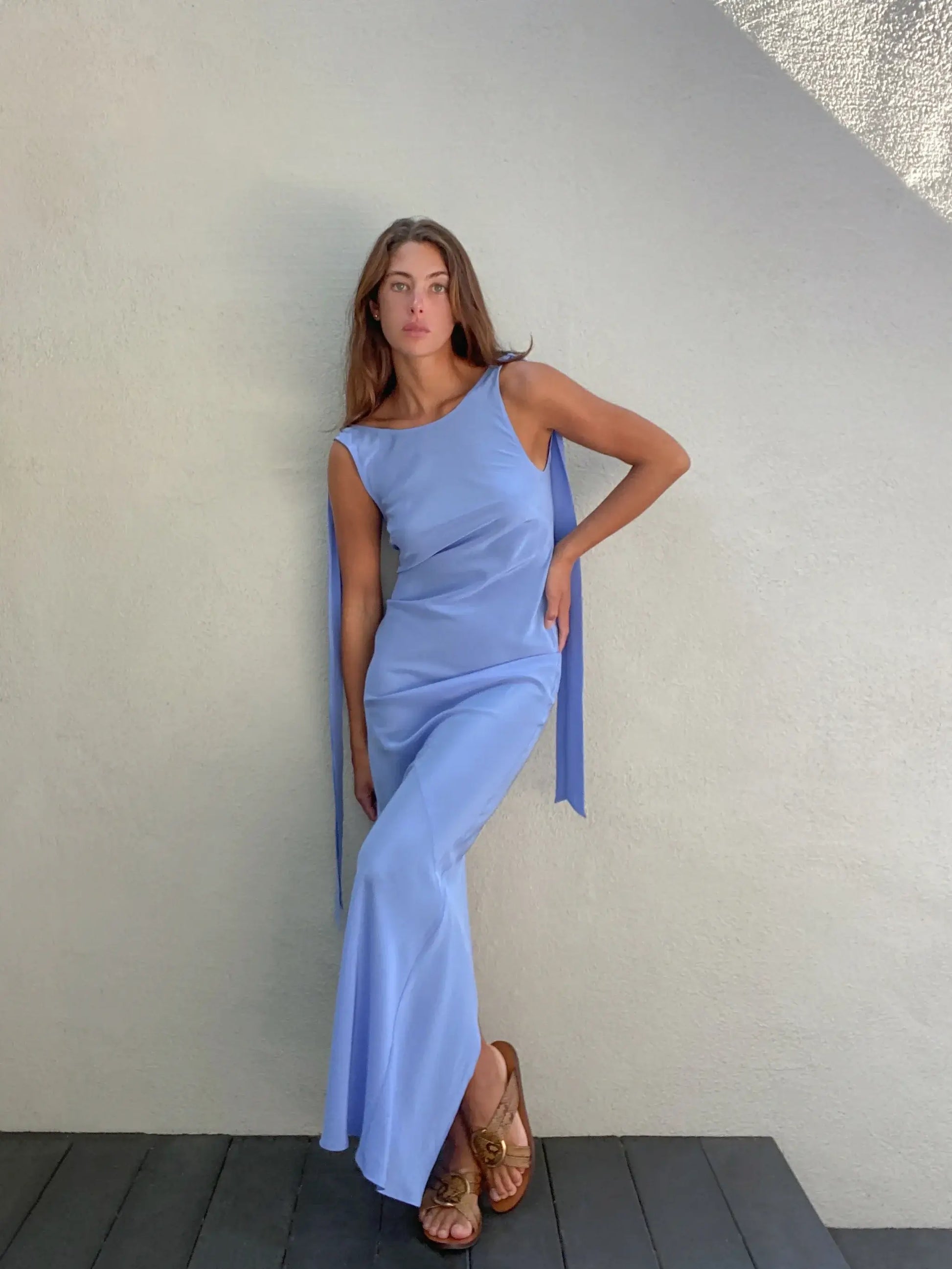 Model wearing and showcasing front of  Caitlin Crisp Wilmer Dress is the perfect shade of blue in a matte silk to suit almost any skin tone