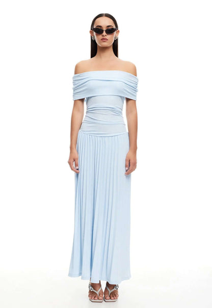 Model wearing a light blue off-the-shoulder maxi dress from Lioness, showcasing effortless glamour and contemporary style.