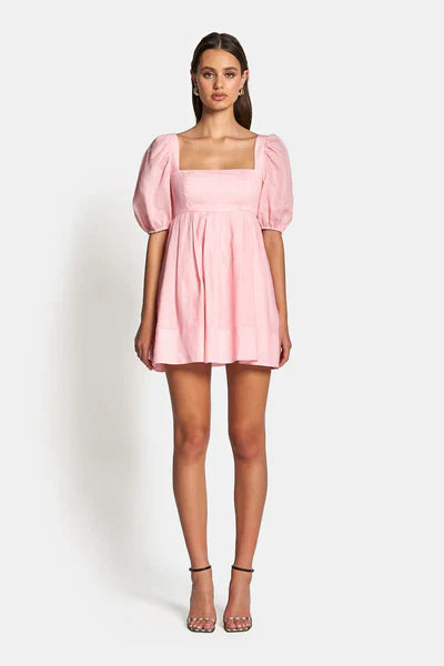 Aerin Open Back Tie Mini Dress in Baby Pink featuring a square neckline and pleated skirt.